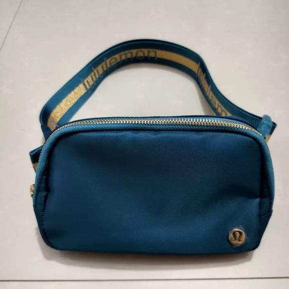 lululemon athletica Handbags - Lululemon Teal With Gold Accents Belt Bag 1L BNWT
